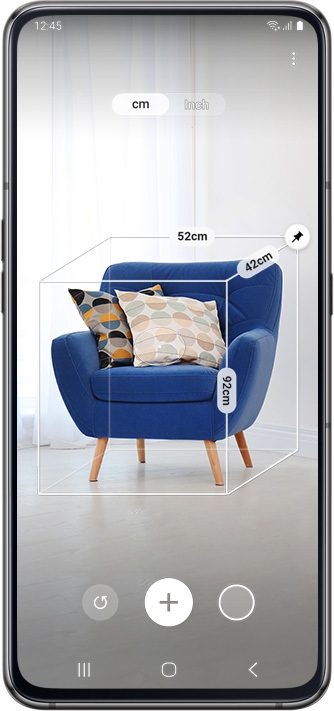 Galaxy A80 scanning a blue chair onscreen to calculate measurements.